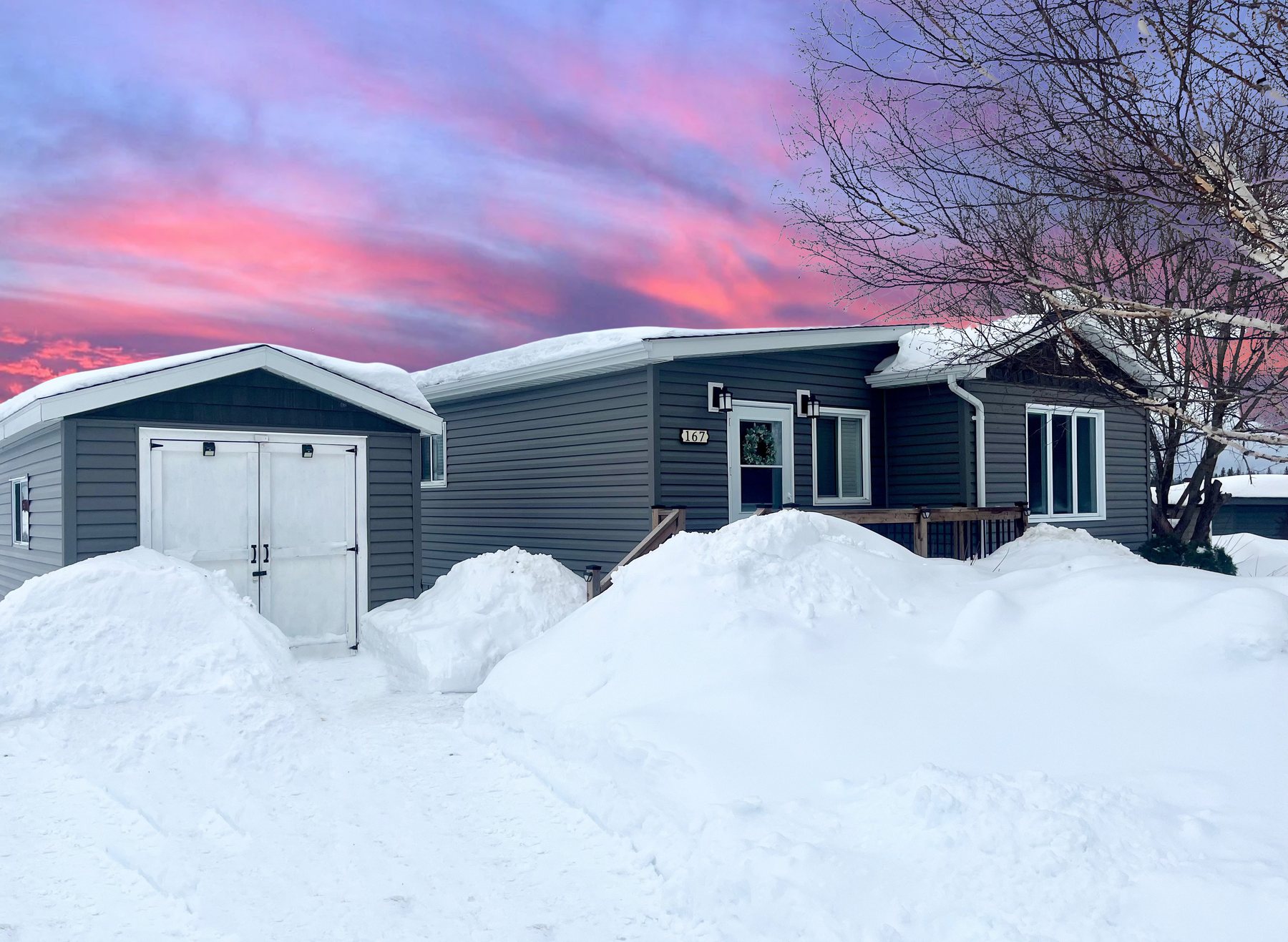 A mobile home in winter at Cochrane Mobile Home Park